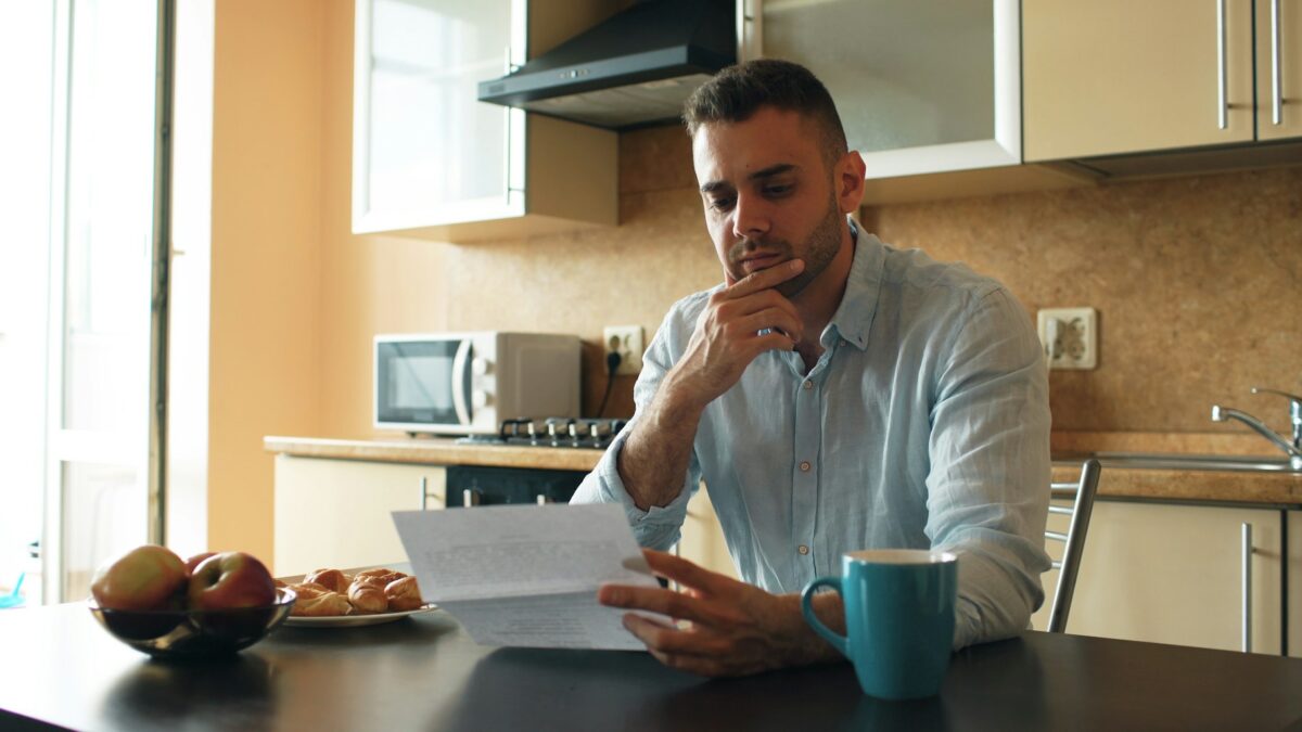 concerned homebuyer reviewing mortgage documents