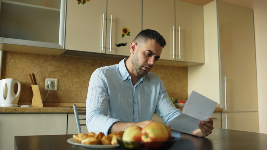 person checking bills inflation stress