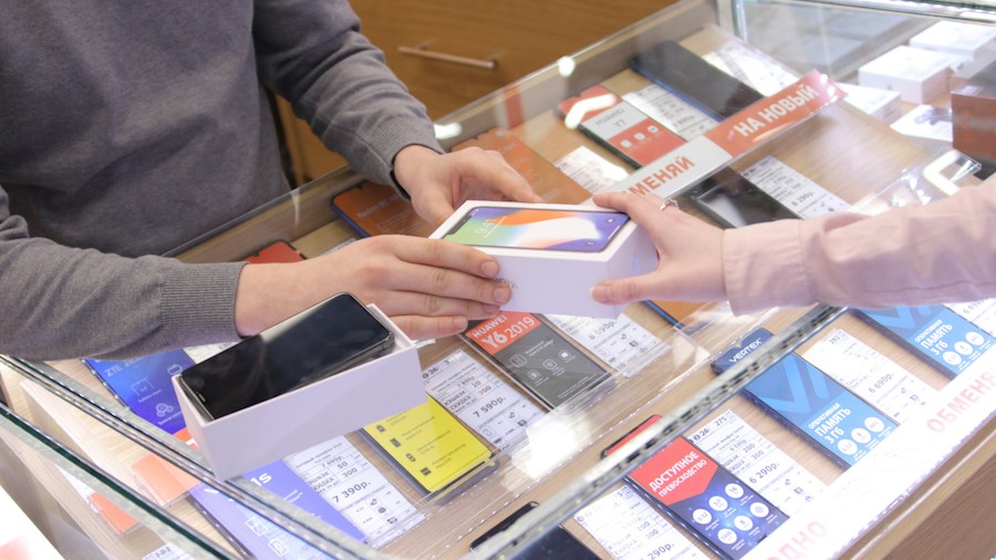 person choosing phone retail display