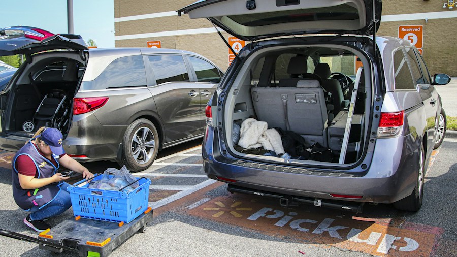 person loading groceries into car