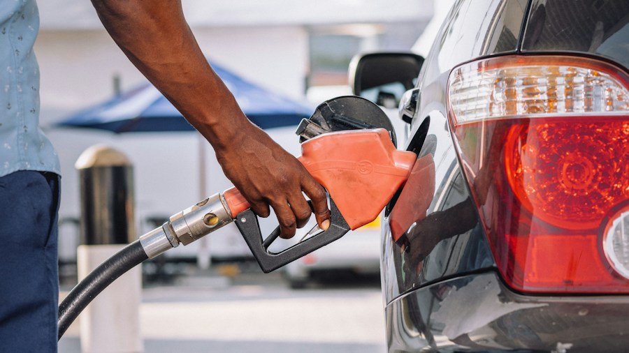 person pumping gas at station