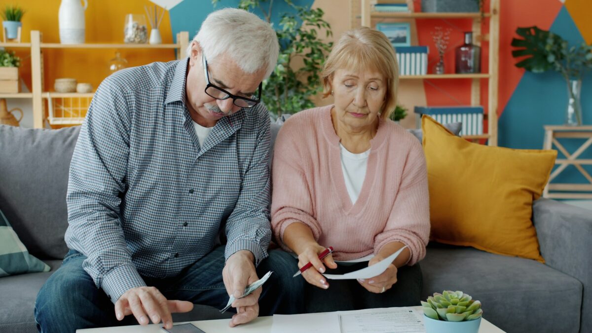senior couple reviewing budget paperwork